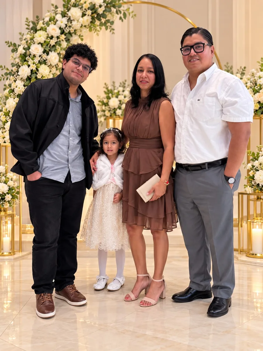Jimmy and his family at an event, in front of a white flower arch