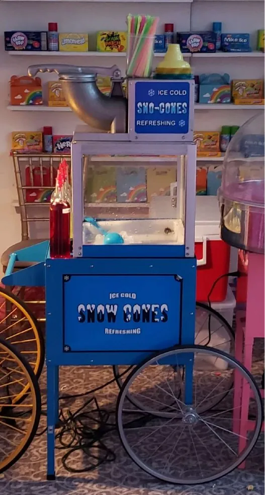 Blue snow cone cart with syrups on top